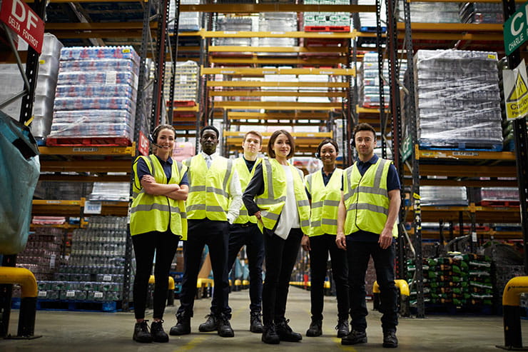 Where to recruit warehouse workers: Group portrait of staff at distribution warehouse