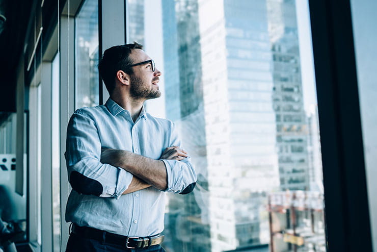 Person staring out office building window