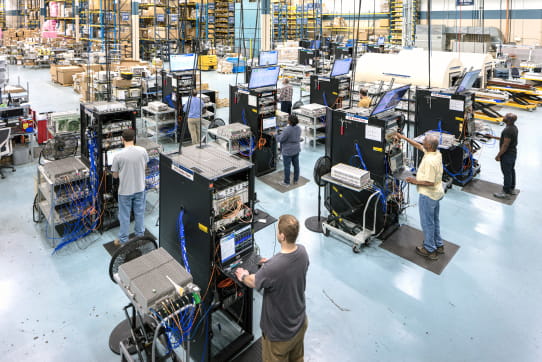 Employees working on machines in a warehouse